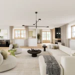 Das Bild zeigt ein modern eingerichtetes Wohnzimmer mit Naturlicht. Zentrale Elemente sind ein weißes Sofa, zwei grüne Sessel, ein schwarzer Couchtisch und ein Essbereich im Hintergrund. Die Raumgestaltung ist hell und einladend.